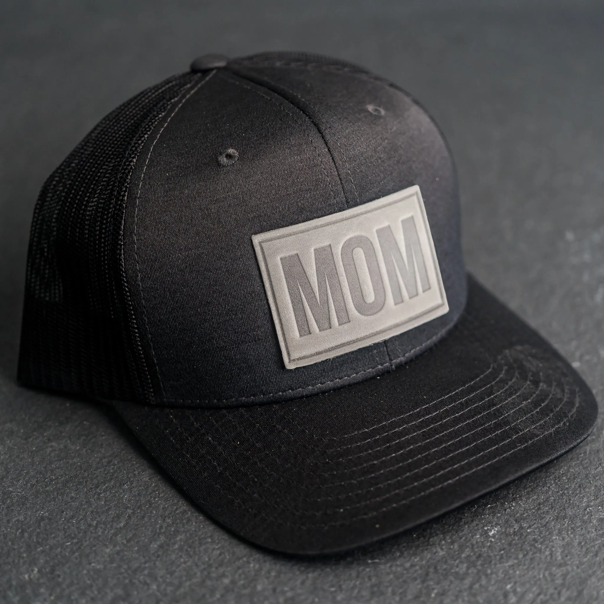 Leather Patch Performance Style Trucker Hat - Mom Stamp - Block Font